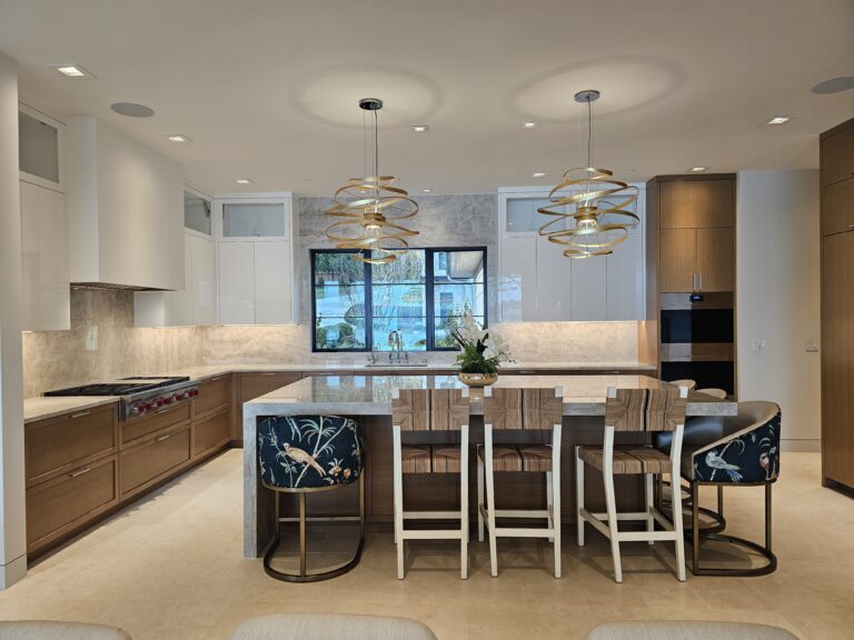 Full kitchen view with quartzite island seating and matching stone backsplash on both walls