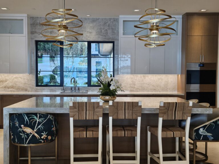 Looking across the quartzite island to the windows and pendants, stools in the foreground