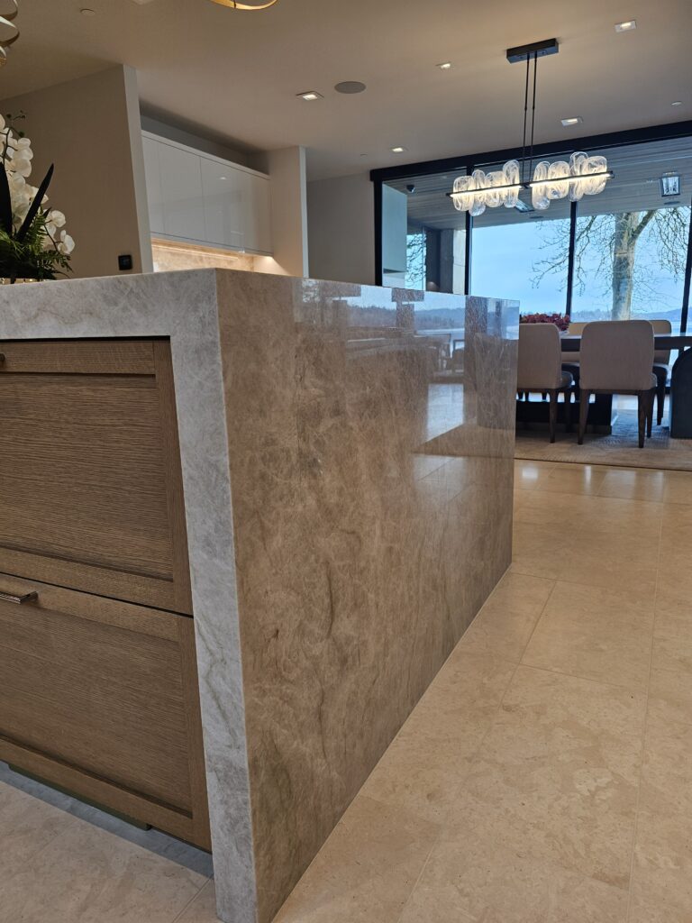 Edge detail of the quartzite island looking toward the dining area chandelier