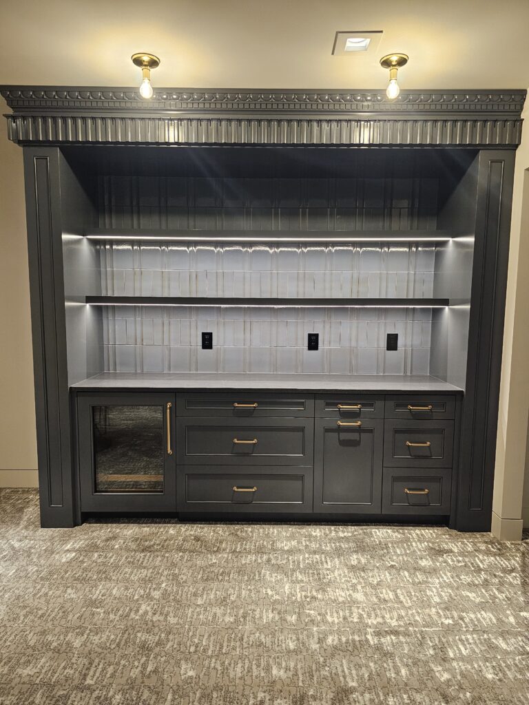 Built-in bar hutch with lit floating shelves, white stacked tile backsplash, and crown detail