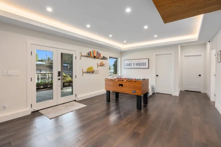 Game area with foosball table, glass french doors to the patio, and tray ceiling with cove lighting
