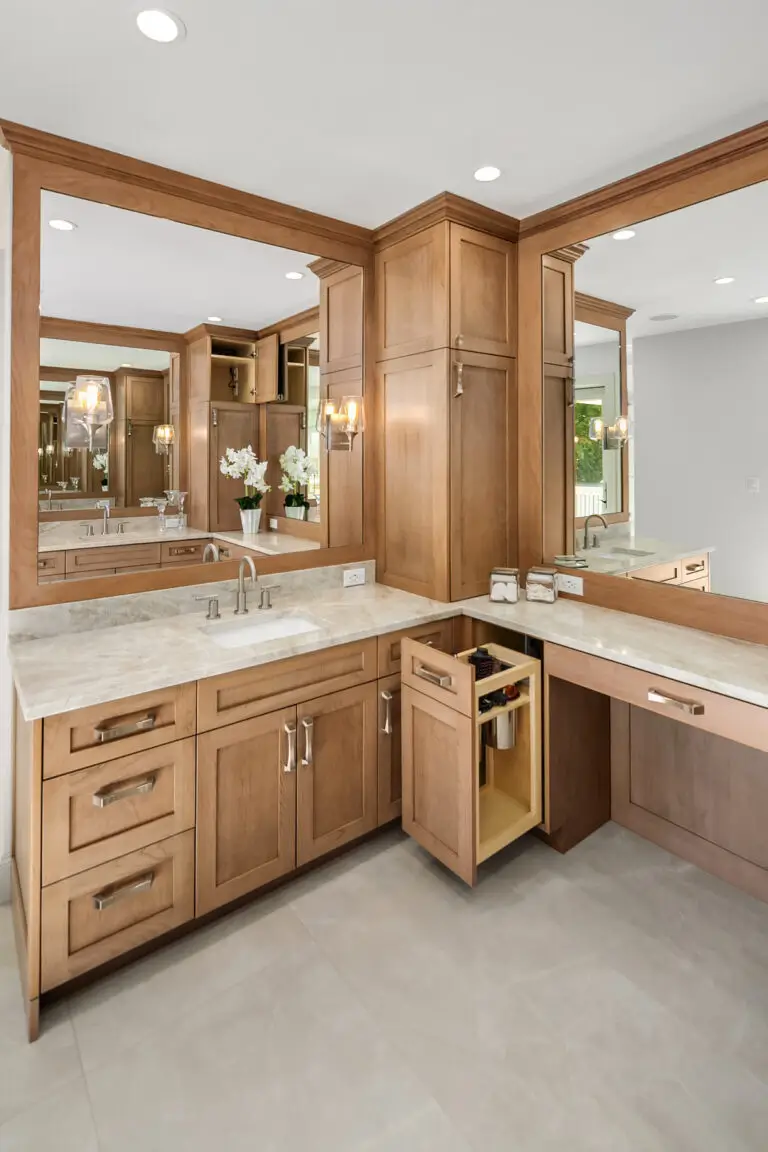 Cherry vanity with pull-out blow dryer cabinet storing hair tools beside the makeup counter