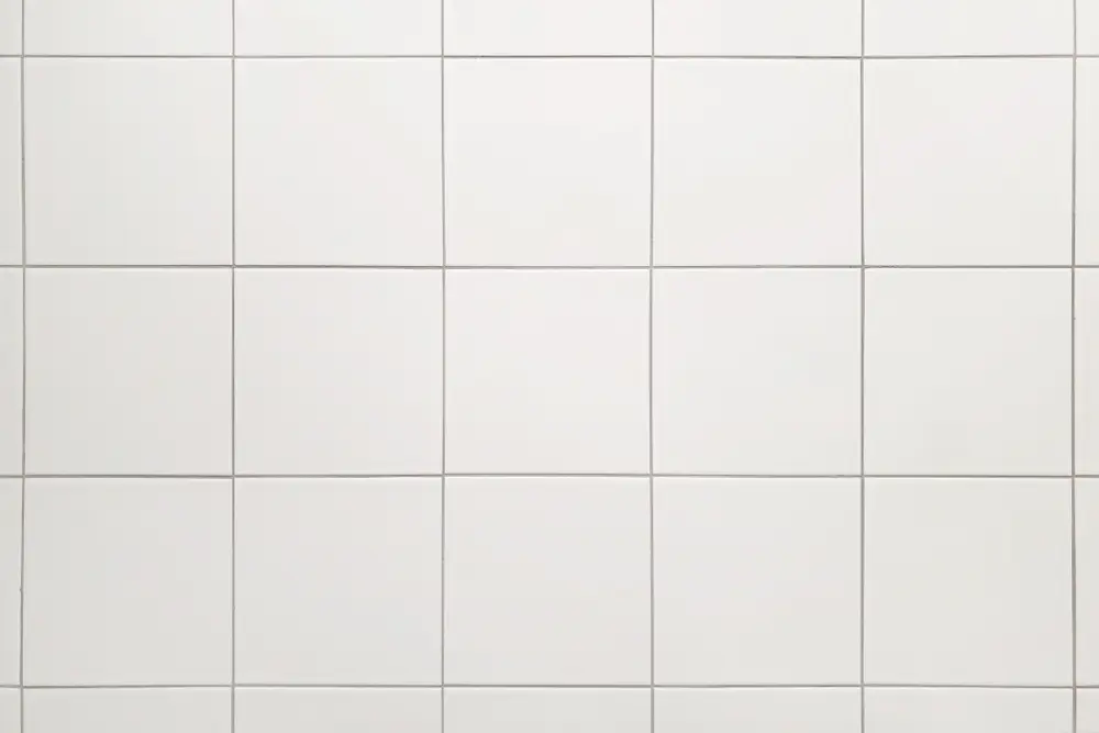 Plain white square ceramic wall tiles with light gray grout