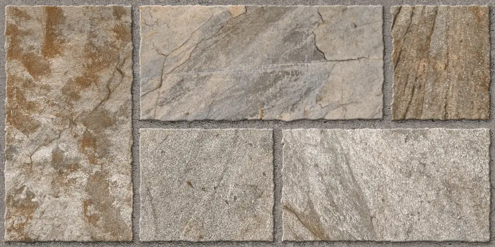 Rustic stone-look porcelain wall tiles in gray and rust tones set in mortar